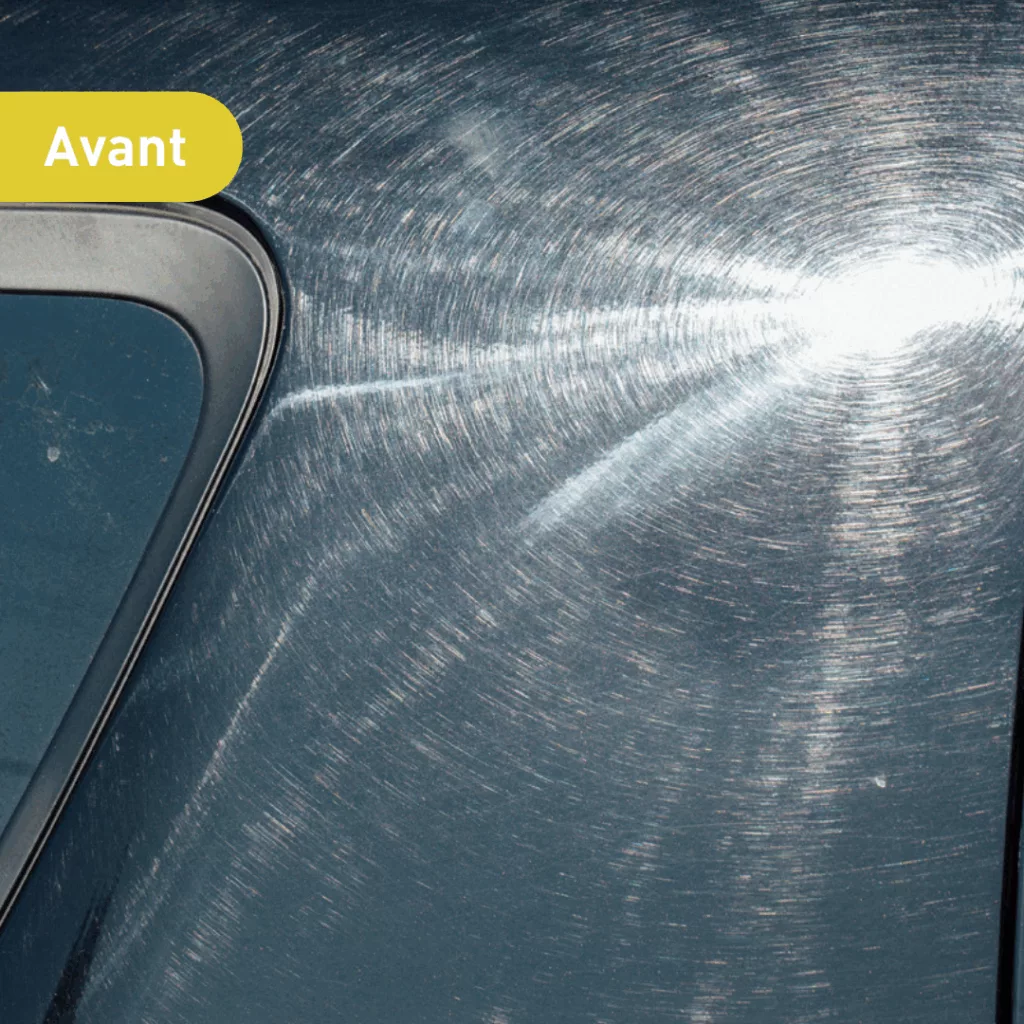 Vue avant d'une voiture d'occasion montrant une surface métallique légèrement rayée et un reflet de lumière, soulignant l'état général du véhicule